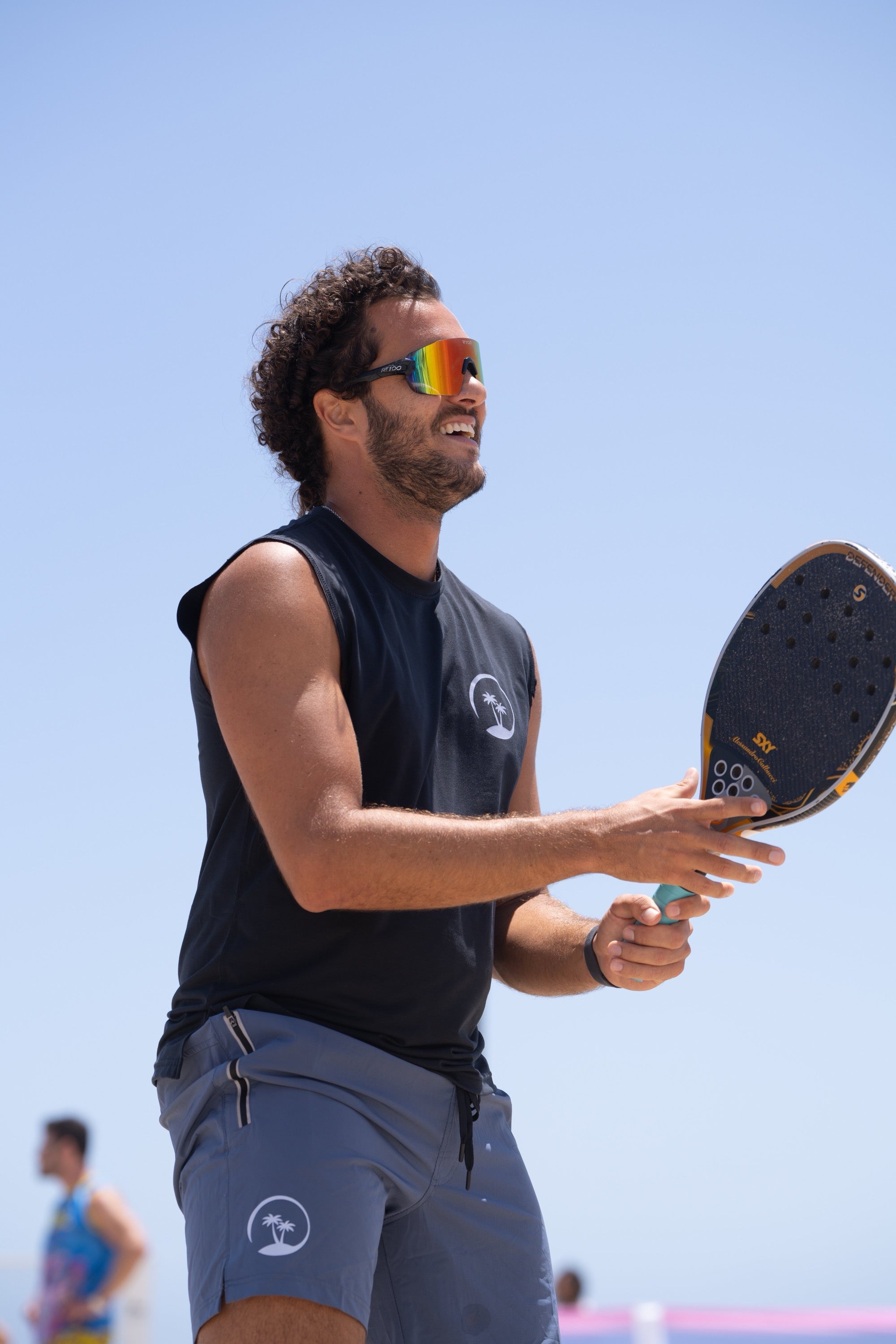 BTS-certified beach tennis player with paddle at Santa Monica beach
